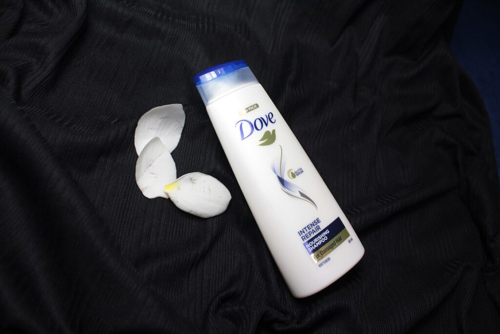 Mehrere Shampooflaschen stehen nebeneinander auf einem Regalbrett im Verkaufsraum